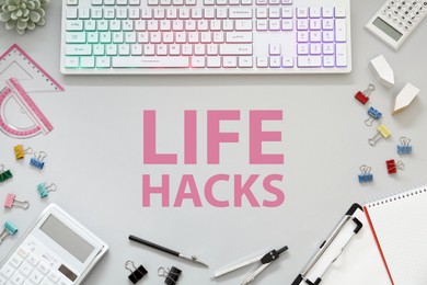 Image of Words Life Hacks on white table, Workplace with computer keyboard and stationery, flat lay