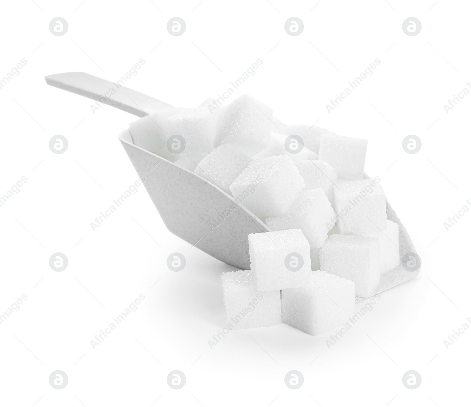 Photo of Sugar cubes in scoop isolated on white