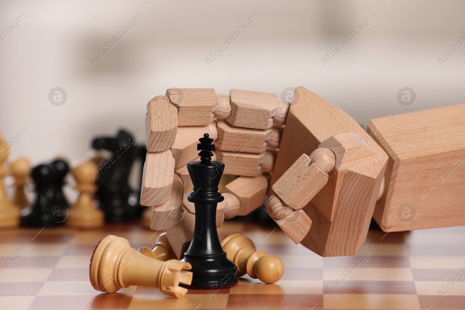 Photo of Robot playing chess, closeup. Wooden hand representing artificial intelligence