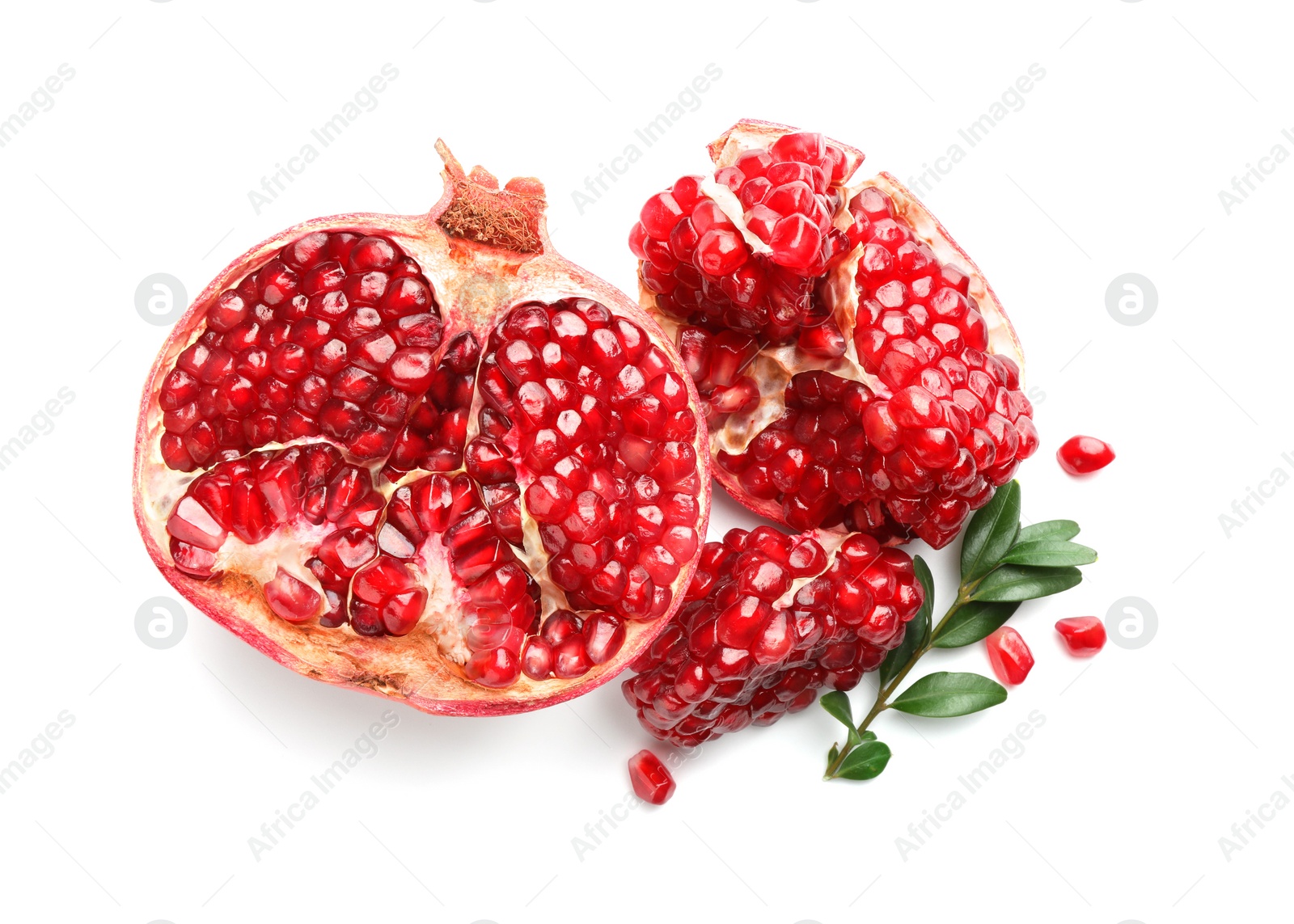 Photo of Fresh cut pomegranate and branch isolated on white, top view