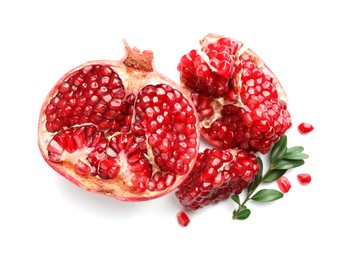 Photo of Fresh cut pomegranate and branch isolated on white, top view