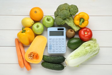 Photo of Calculator and food products on white wooden table, flat lay. Weight loss concept