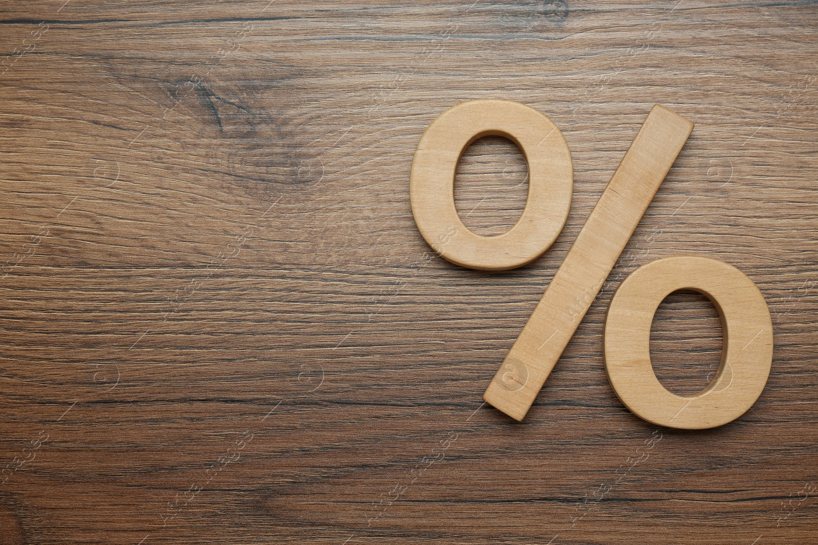 Photo of Percent sign on wooden table, flat lay. Space for text