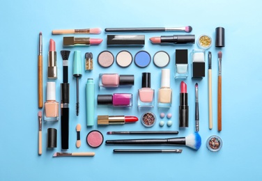 Photo of Flat lay composition with decorative cosmetics on color background