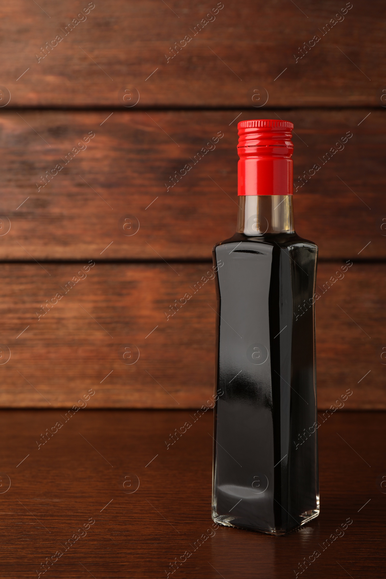 Photo of Bottle of soy sauce on wooden table