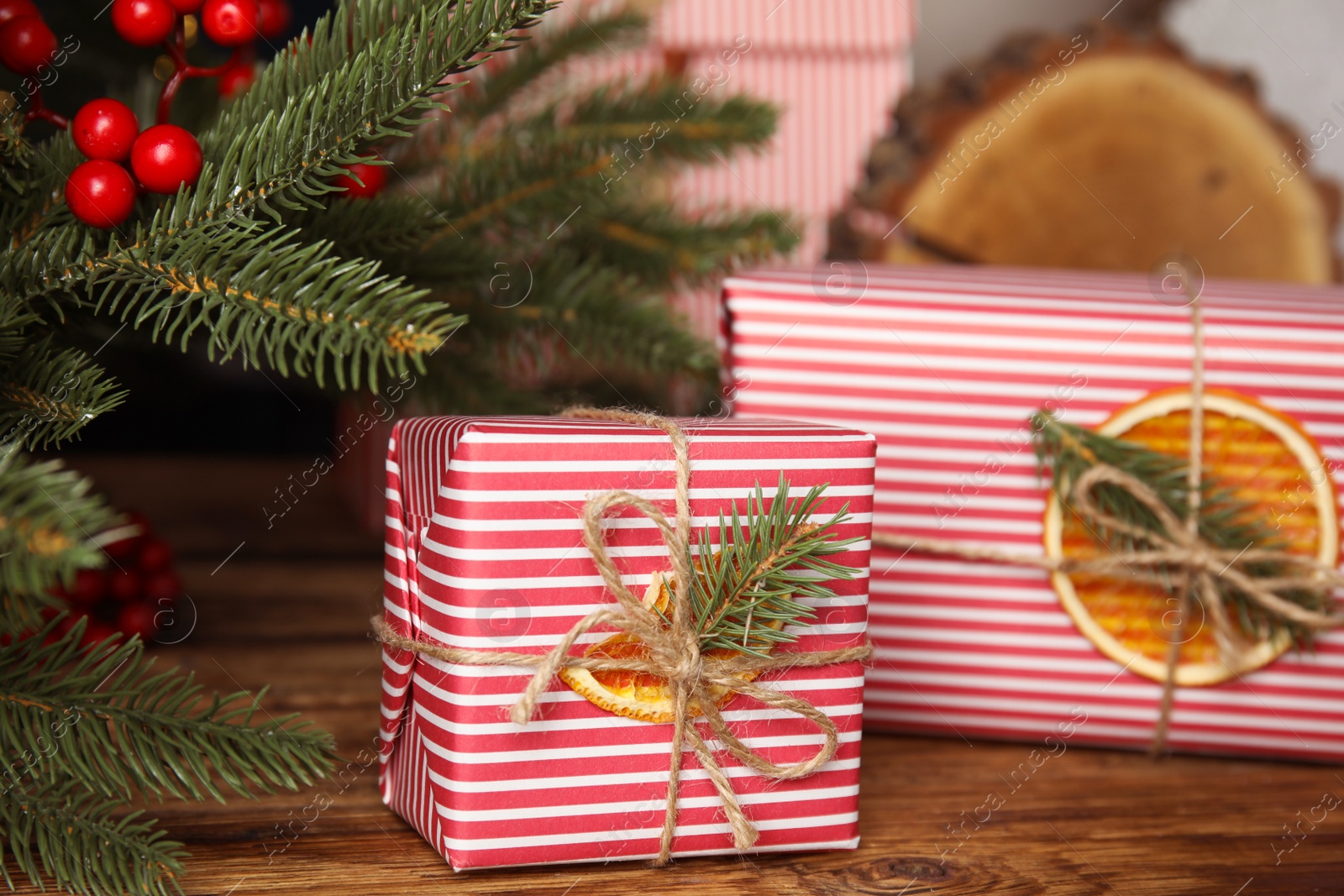 Photo of Beautifully wrapped gift boxes on wooden table