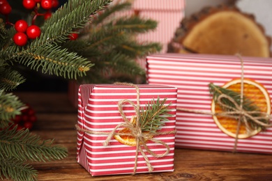 Photo of Beautifully wrapped gift boxes on wooden table