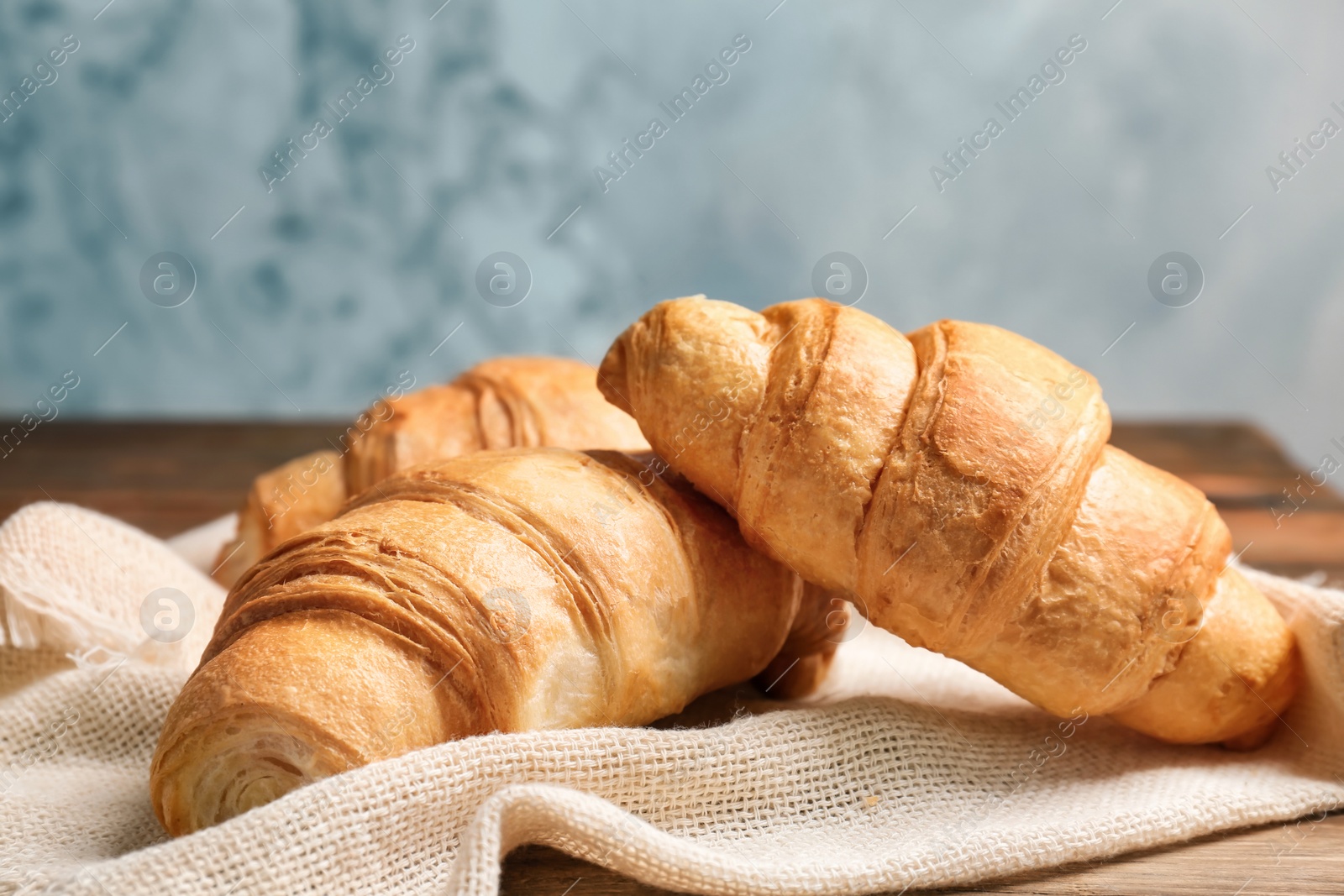 Photo of Tasty croissants on table, closeup