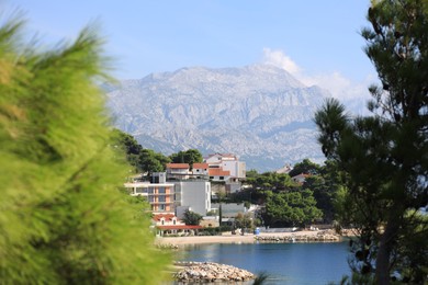 Photo of Resort and mountain under blue sky near sea