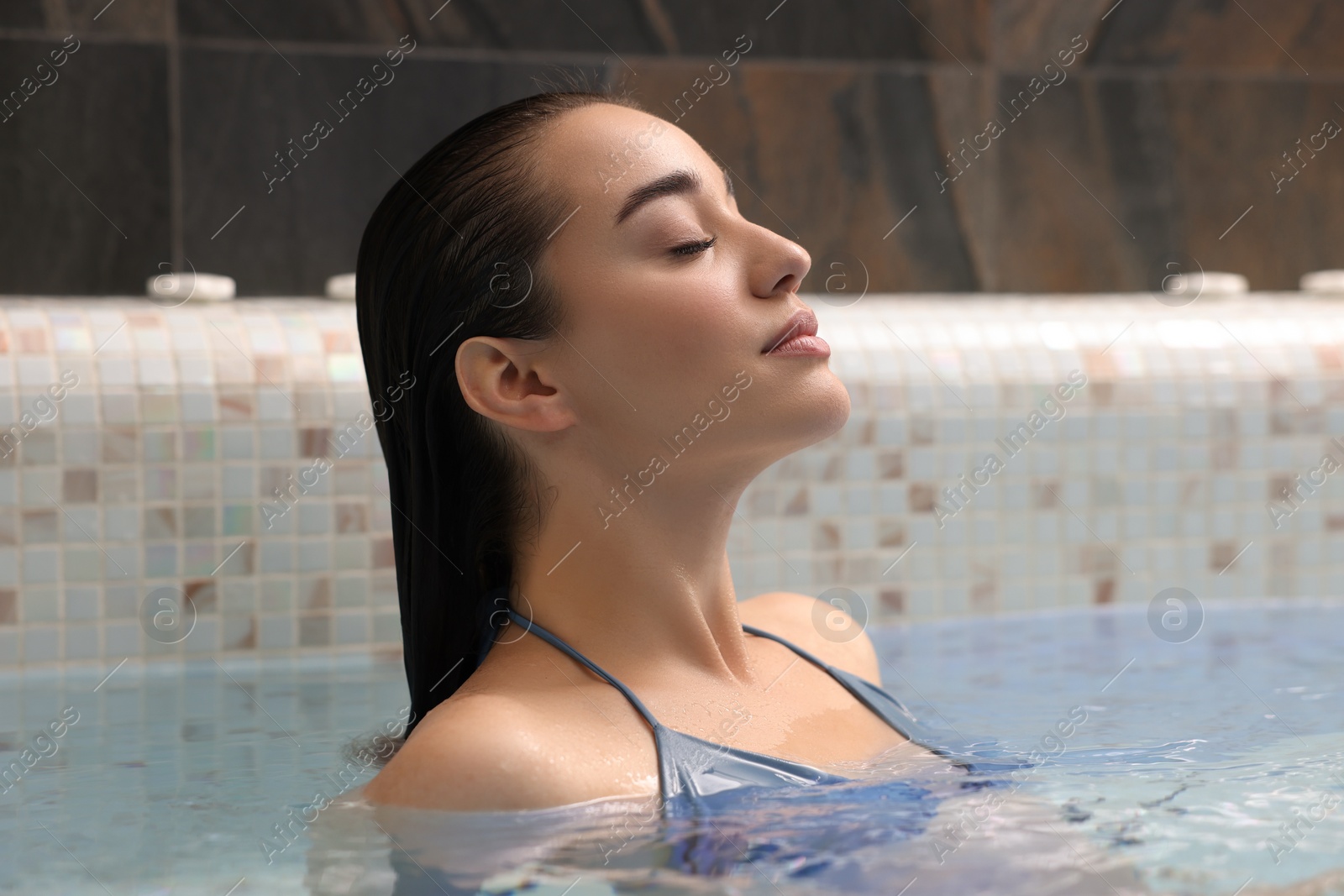 Photo of Beautiful woman relaxing in spa swimming pool