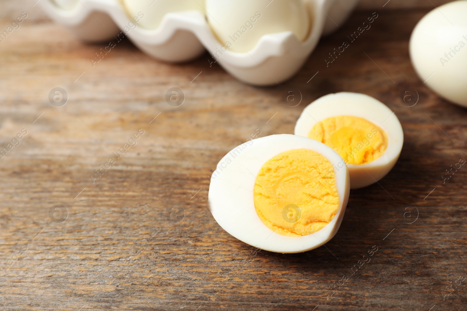 Photo of Hard boiled egg on wooden table. Space for text