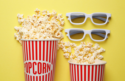 Photo of Flat lay composition with delicious popcorn on yellow background