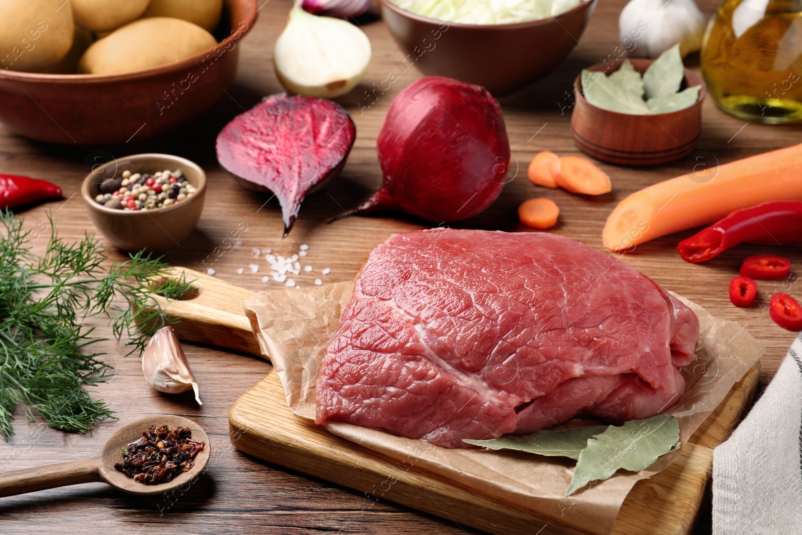 Photo of Fresh ingredients for borscht on wooden table