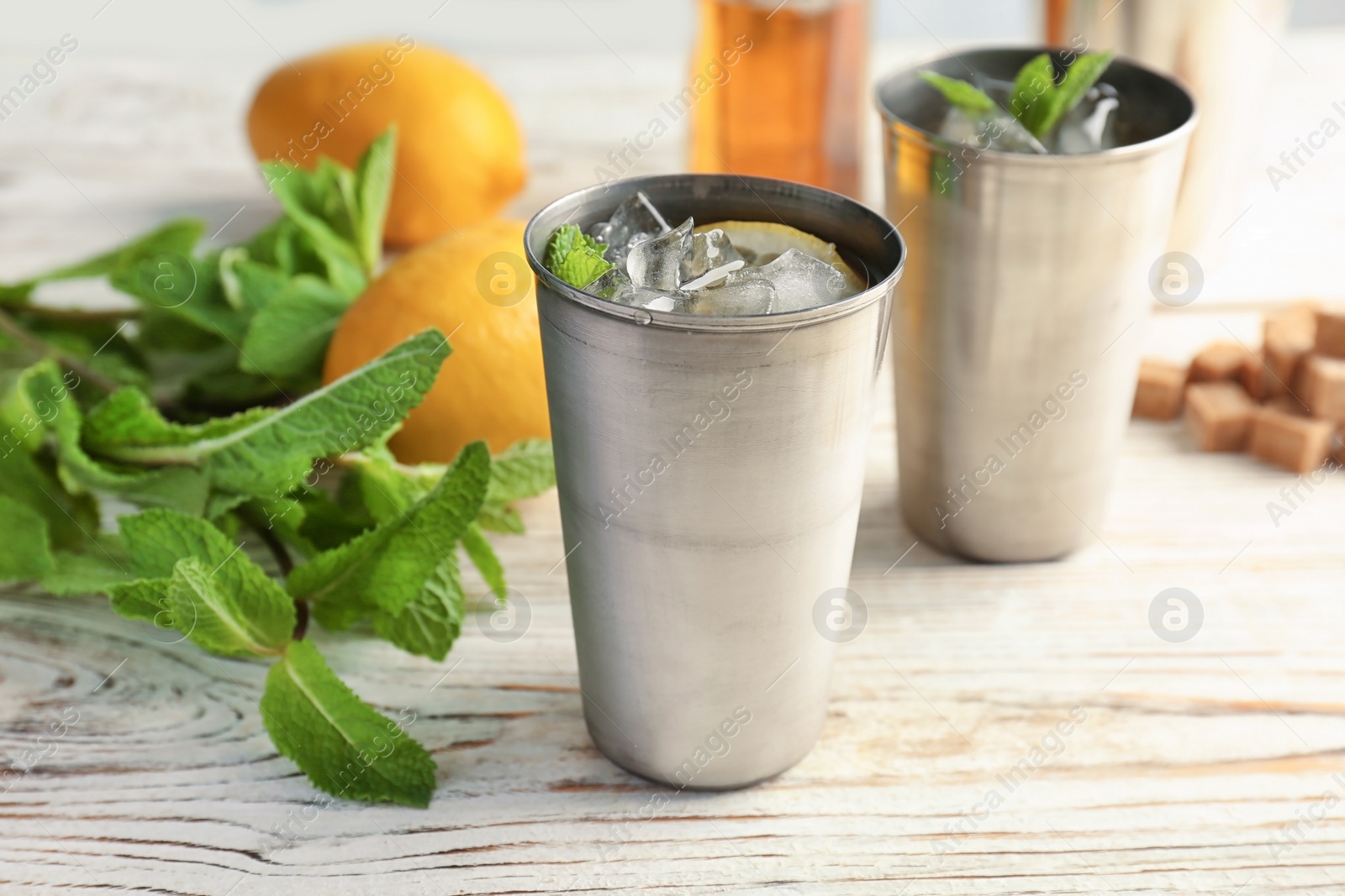 Photo of Composition with delicious mint julep cocktail on table