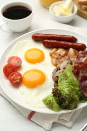 Delicious breakfast with sunny side up eggs served on white table, closeup