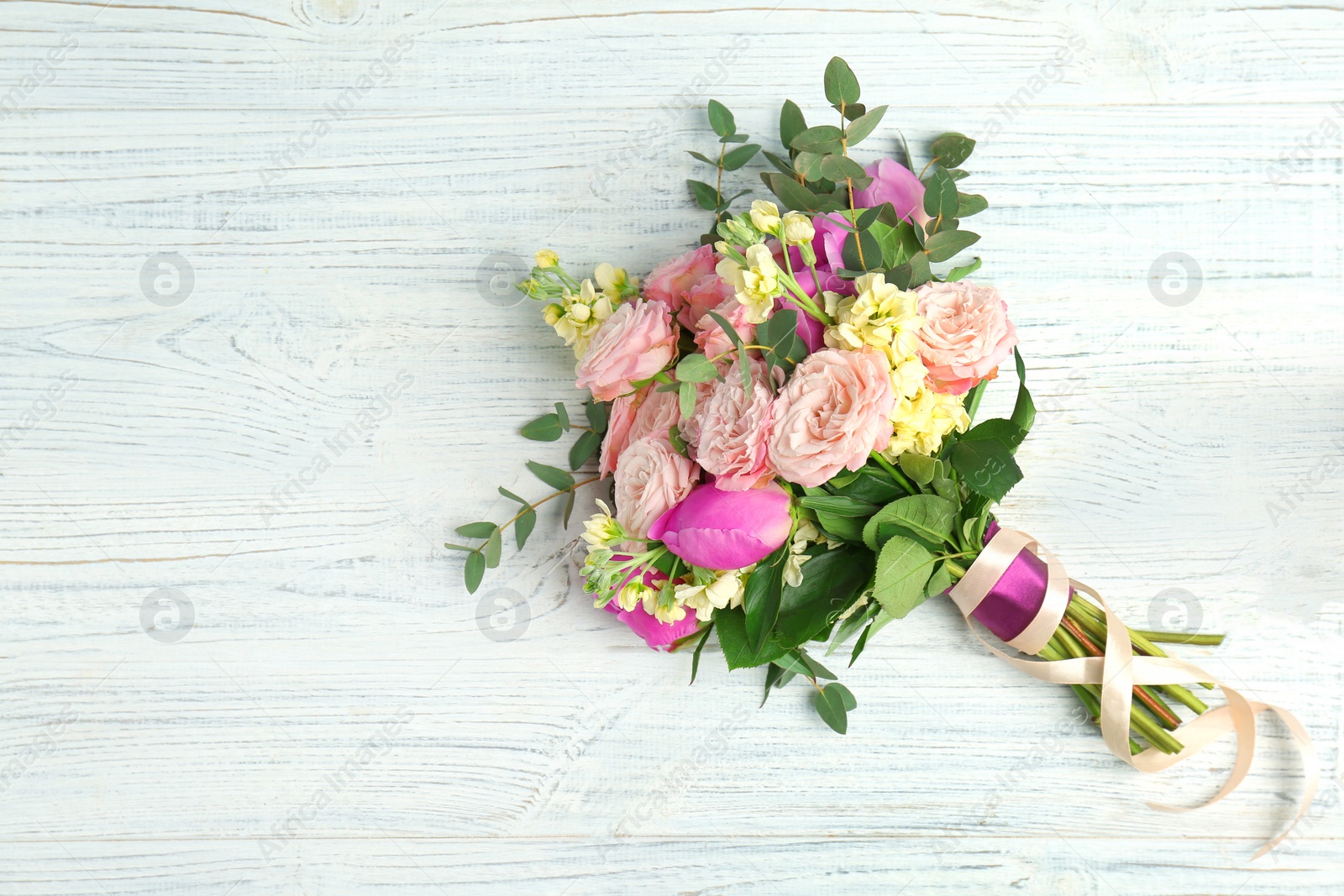 Photo of Bouquet of beautiful fragrant flowers on wooden background