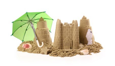 Photo of Pile of sand with beautiful castles, toys and shells isolated on white