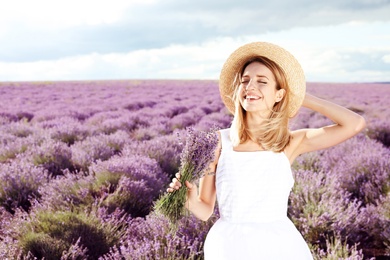 Photo of Young woman with bouquet in lavender field