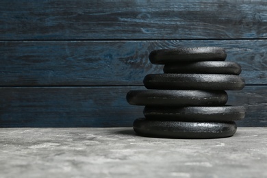 Photo of Composition of dumbbell plates on floor. Space for text