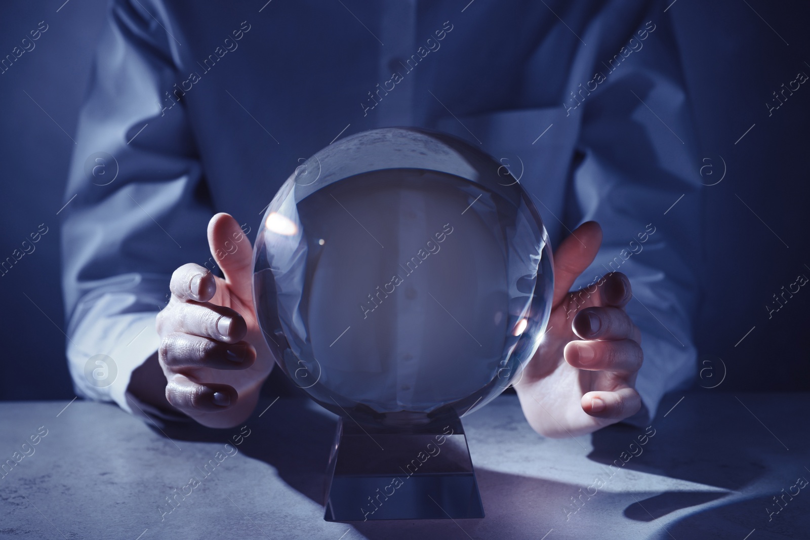 Photo of Businesswoman using crystal ball to predict future at table, closeup