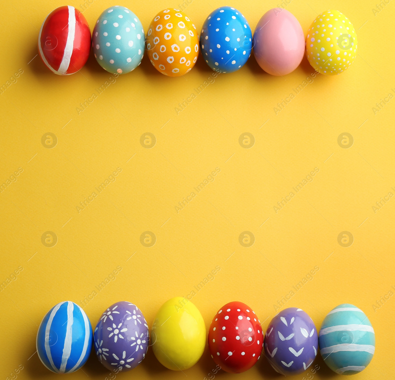 Photo of Flat lay composition of painted Easter eggs on color background, space for text