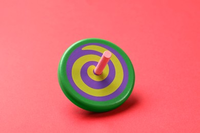 Photo of One colorful spinning top on red background