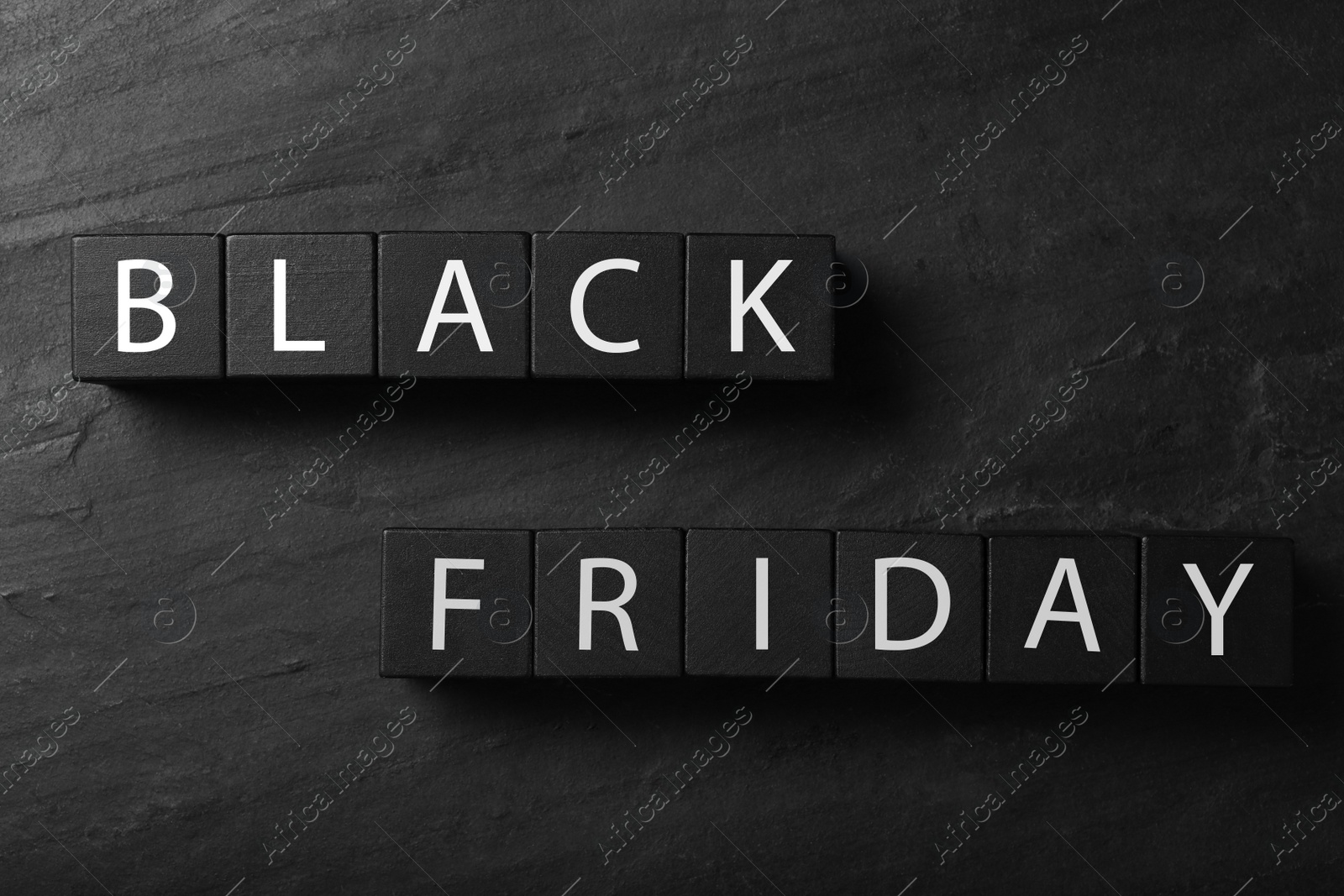 Photo of Cubes with words Black Friday on dark background, flat lay