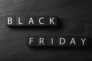 Photo of Cubes with words Black Friday on dark background, flat lay