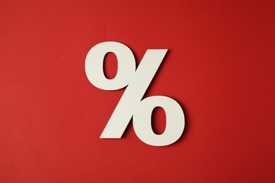 White percent sign on red background, top view