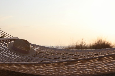 Hammock with hat hanging outdoors. Time to relax