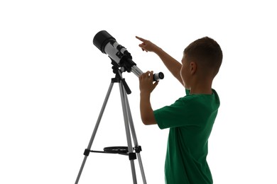 Photo of Little boy with telescope pointing at something on white background