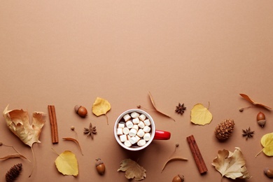 Photo of Flat lay composition with hot drink on beige background, space for text. Cozy autumn