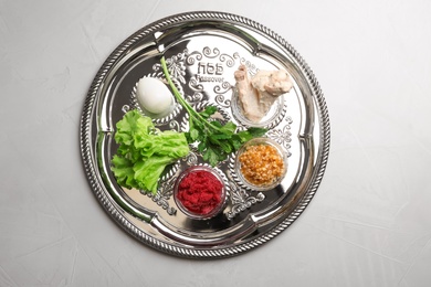 Photo of Traditional Jewish plate with symbolic meal for Passover (Pesach) Seder on table, top view