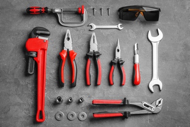 Photo of Flat lay composition with construction tools on grey background