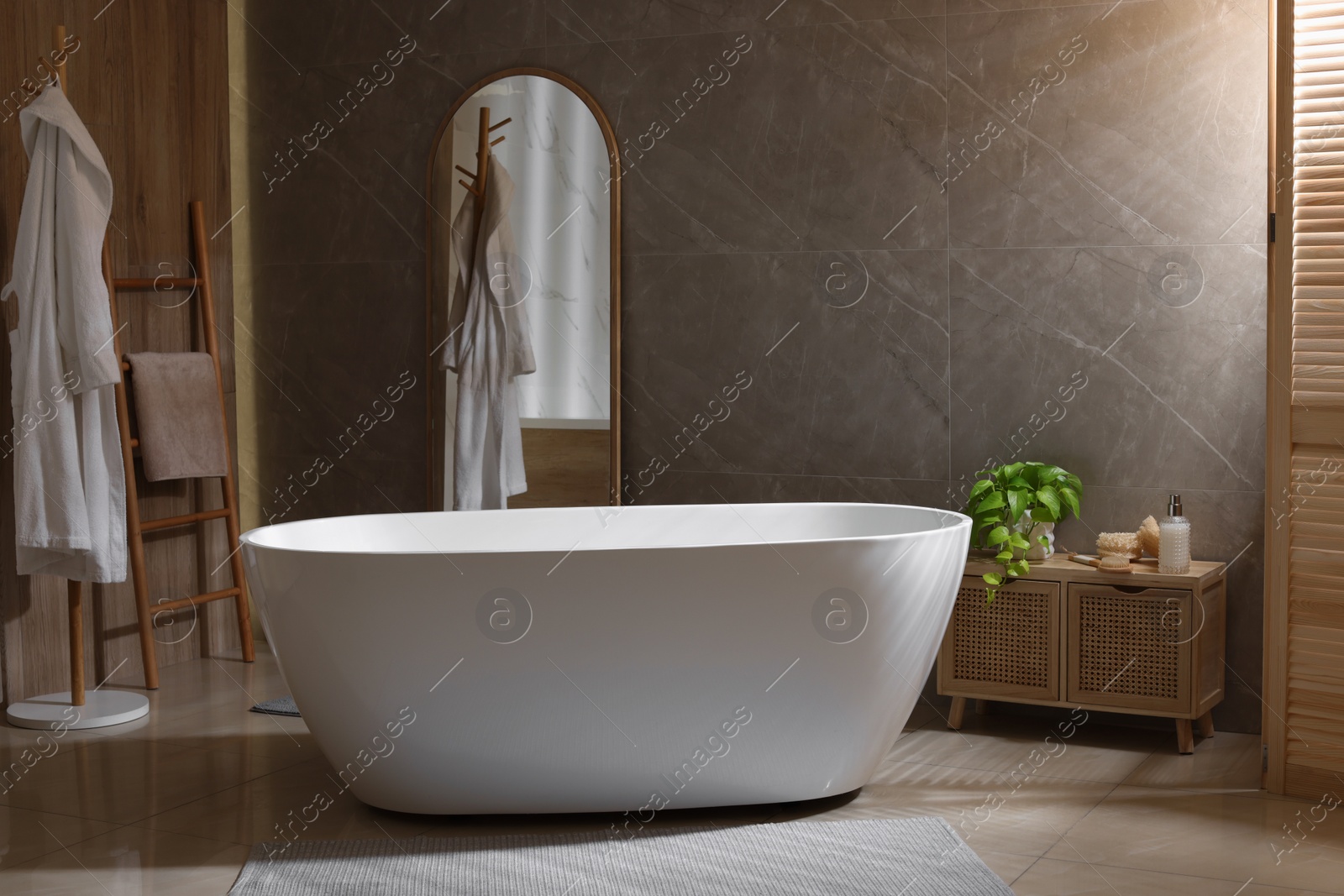 Photo of Stylish bathroom interior with white tub. Idea for design