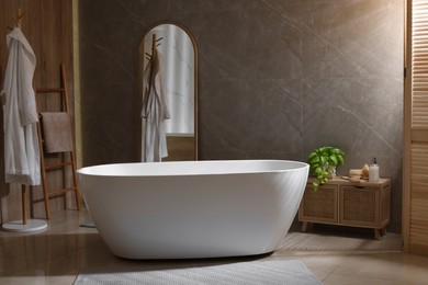 Photo of Stylish bathroom interior with white tub. Idea for design