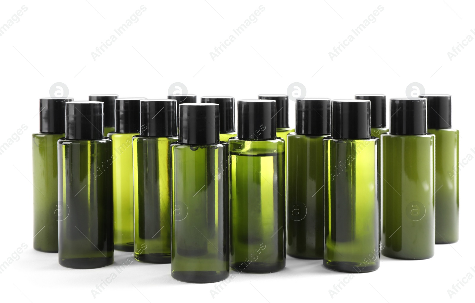 Photo of Mini bottles with cosmetic products on white background