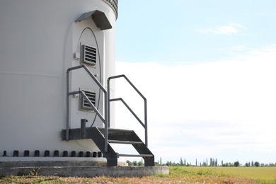 Photo of Entrance to wind turbine power generator outdoors. Alternative energy source