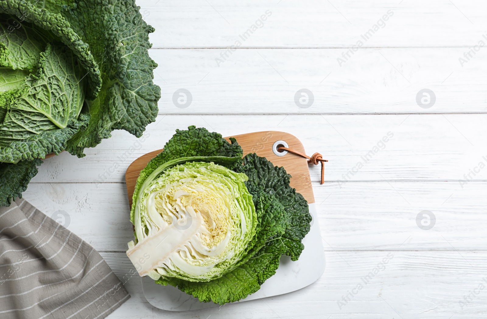 Photo of Fresh green savoy cabbages on white wooden table, flat lay. Space for text