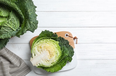 Photo of Fresh green savoy cabbages on white wooden table, flat lay. Space for text