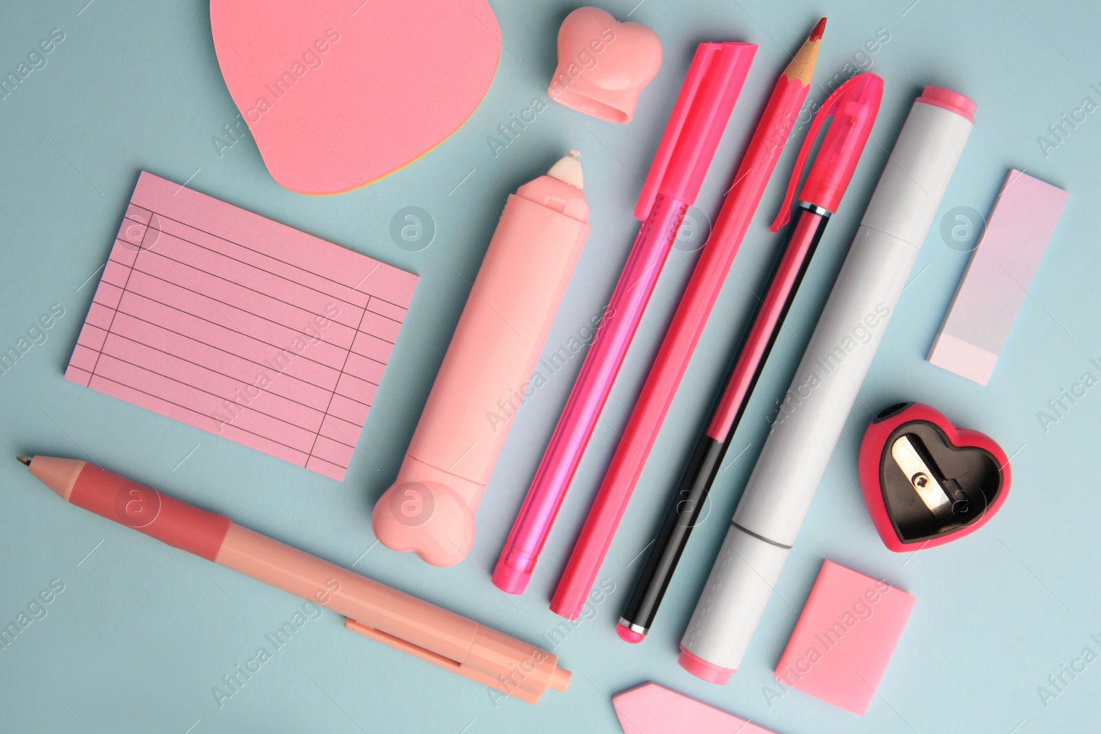 Photo of Flat lay composition with sticky note and other school stationery on light blue background. Back to school