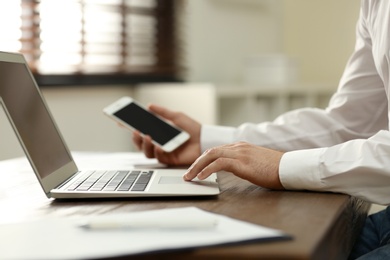 Business trainer working at table in office, closeup