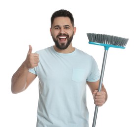 Young man with broom on white background