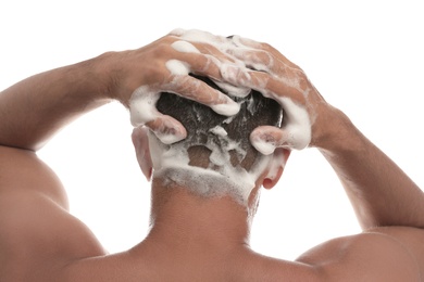 Man washing hair on white background, back view