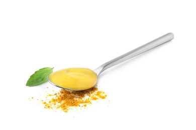 Spoon with tasty curry sauce, powder and basil leaf isolated on white