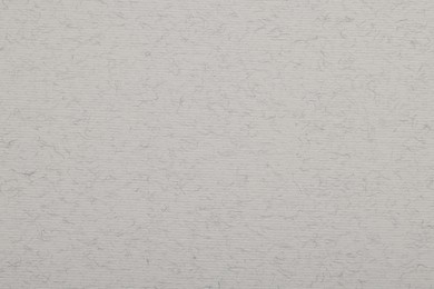 Photo of Texture of light grey paper sheet as background, top view