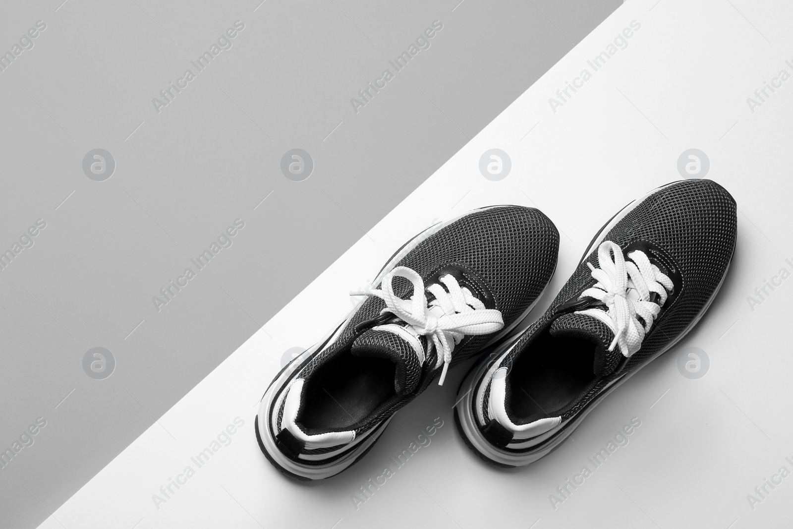 Photo of Flat lay composition of stylish training shoes on light background, space for text