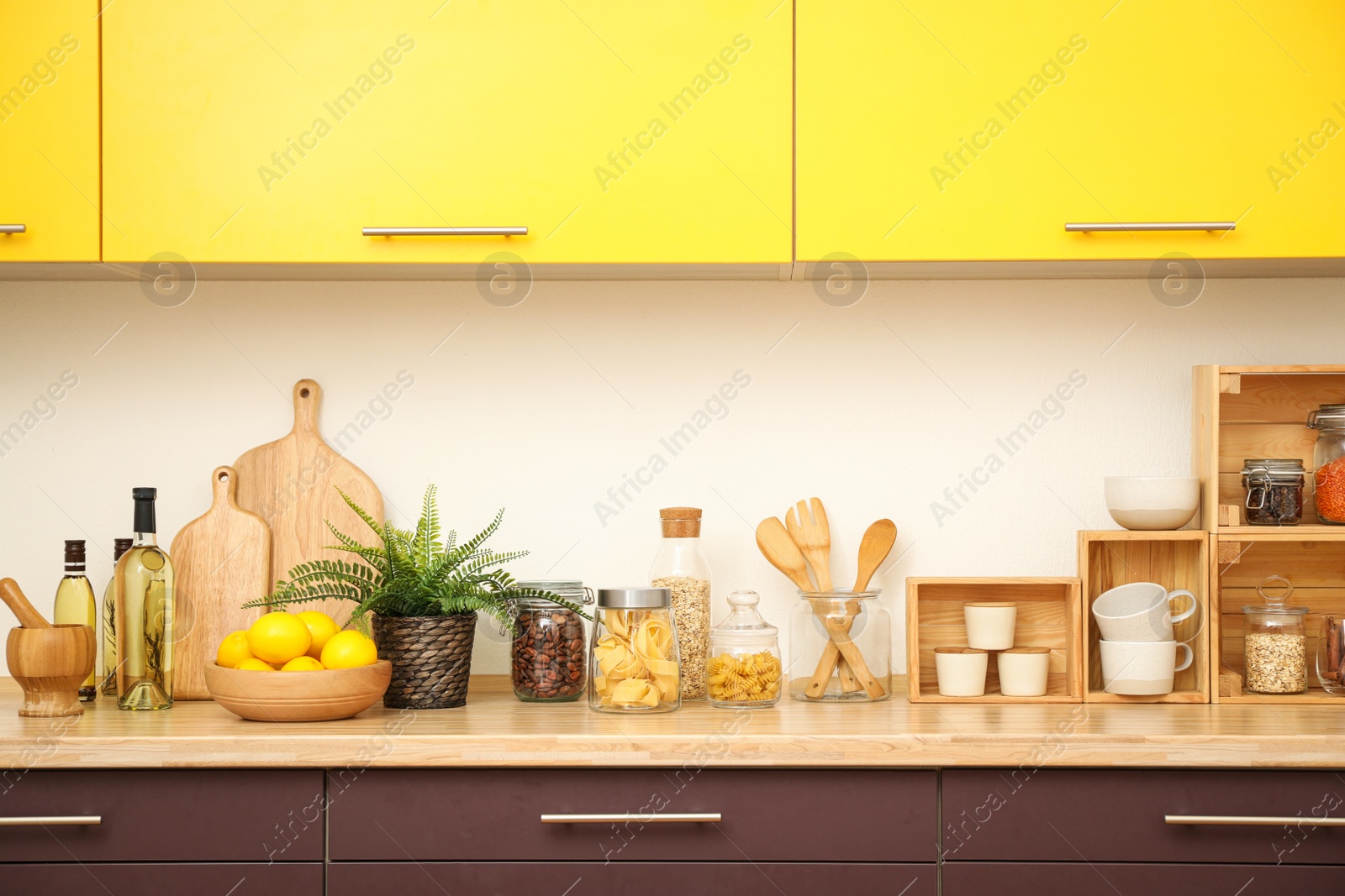 Photo of Stylish kitchen interior with wooden countertop and wall cabinets