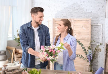 Decorators with beautiful flowers at workplace