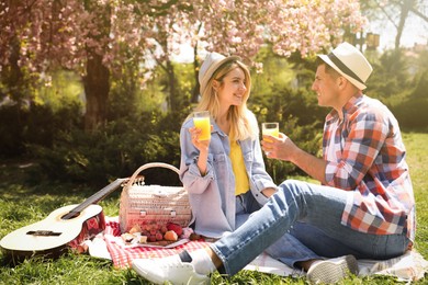 Photo of Happy couple having picnic in park on sunny day